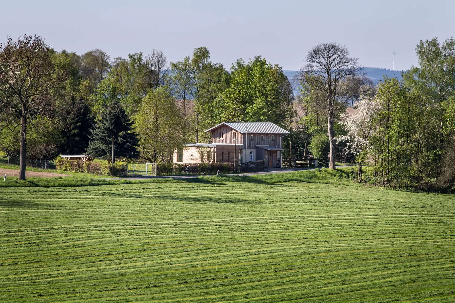 The Railway Keeper's House beyond a broad meadow